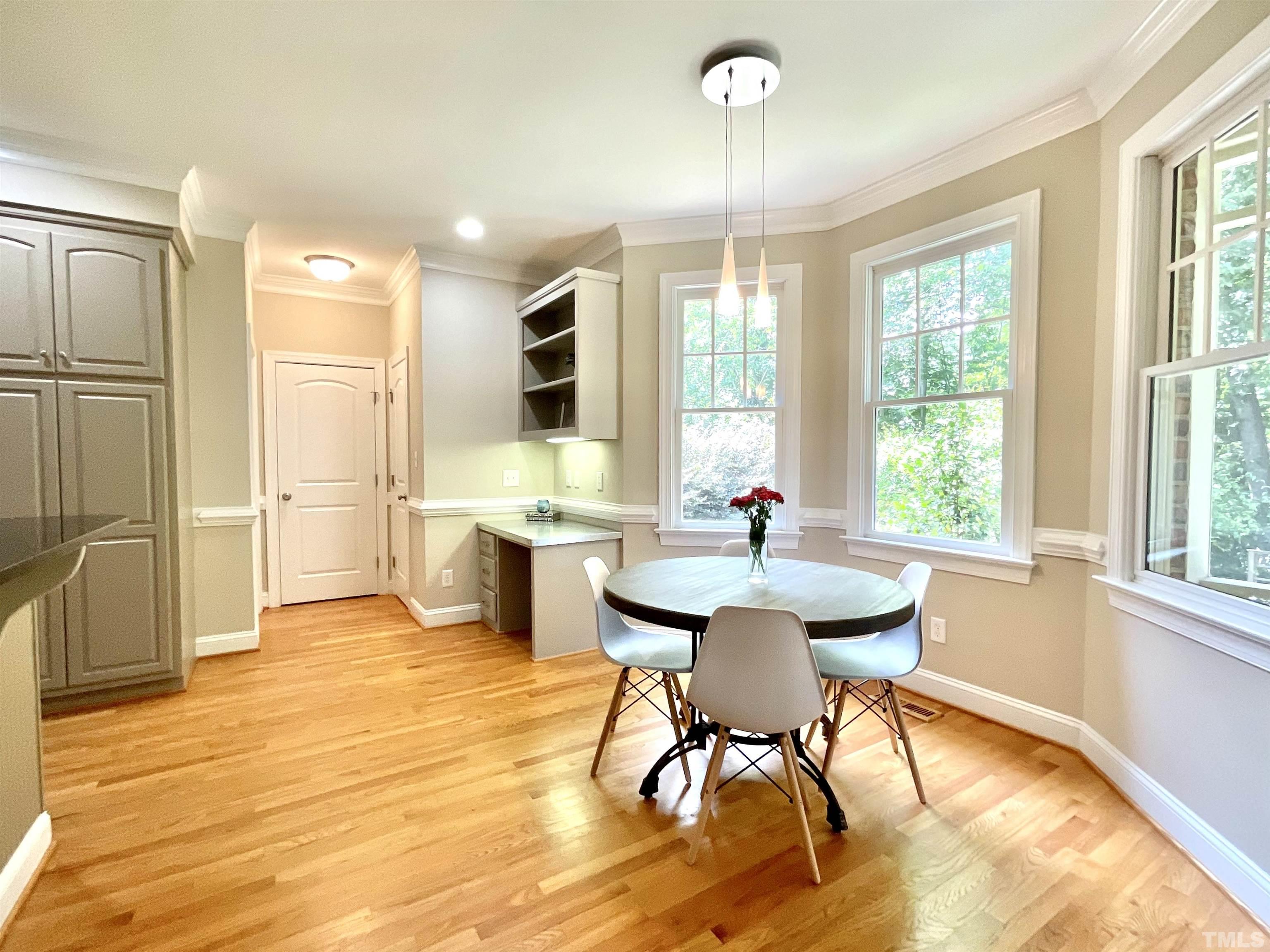 4300 Dula Street Durham, NC 27705 - Photo 19 of 42 a view of a dining room with furniture a chandelier and wooden floor