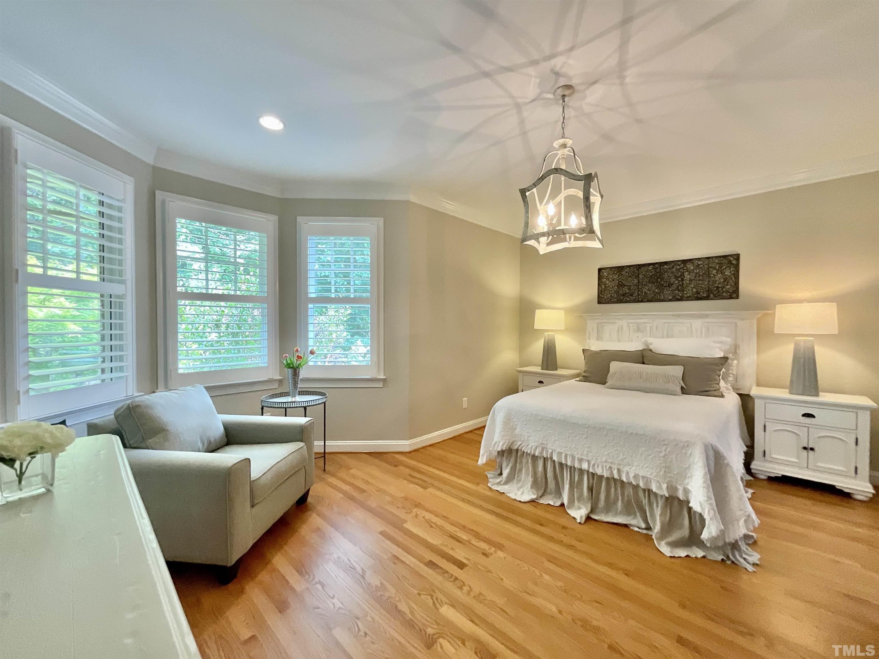 4300 Dula Street Durham, NC 27705 - Photo 22 of 42 a spacious bedroom with a bed and wooden floor