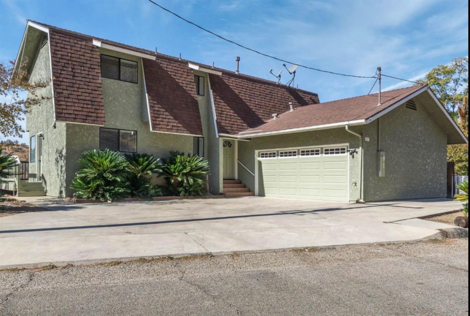 27817 Sky Harbour Road Friant, CA 93626 - Photo 2 of 36 a front view of a house with a garage