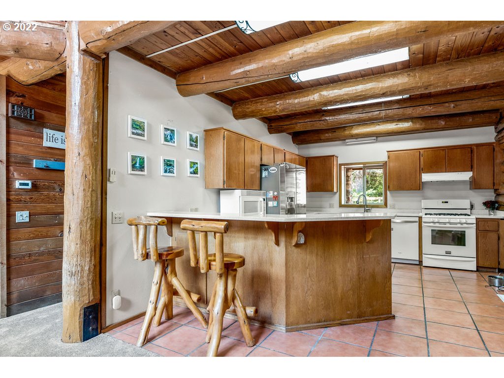 19111 Southeast Langensand Road Sandy, OR 97055 - Photo 7 of 31 a open kitchen with a table and chairs