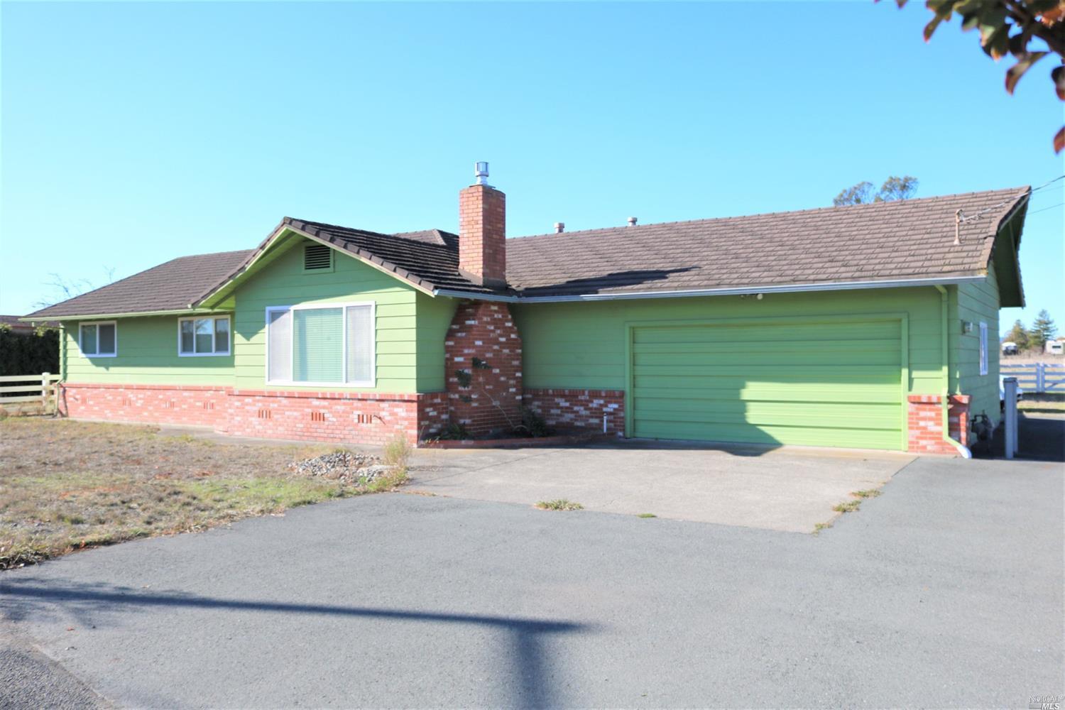 2101 Fulton Road Santa Rosa, CA 95403 - Photo 1 of 1 a front view of a house with a yard and garage