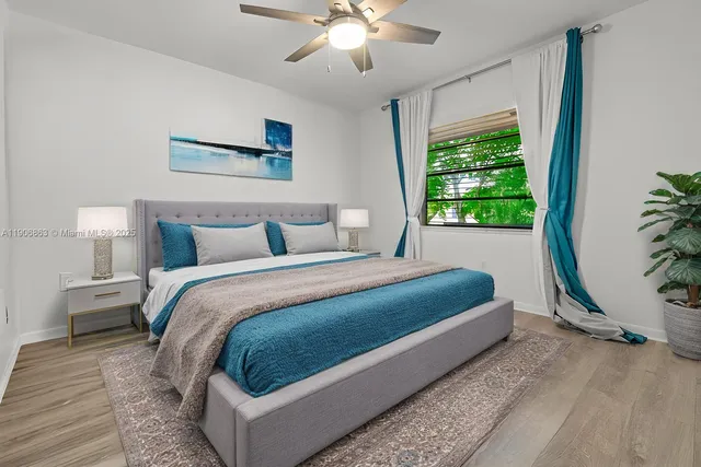 a bedroom with a large bed and a chandelier