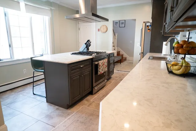 a kitchen with stainless steel appliances granite countertop a sink and a stove