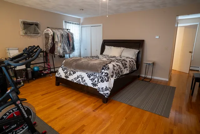 a bed sitting in a bedroom next to a window