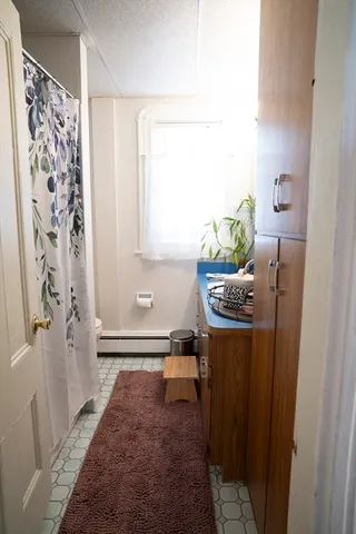 a room with a rug and a window