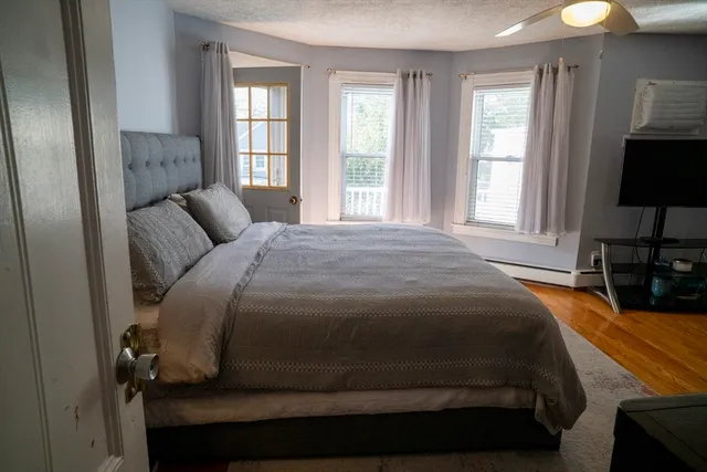 a bedroom with a bed and a flat screen tv