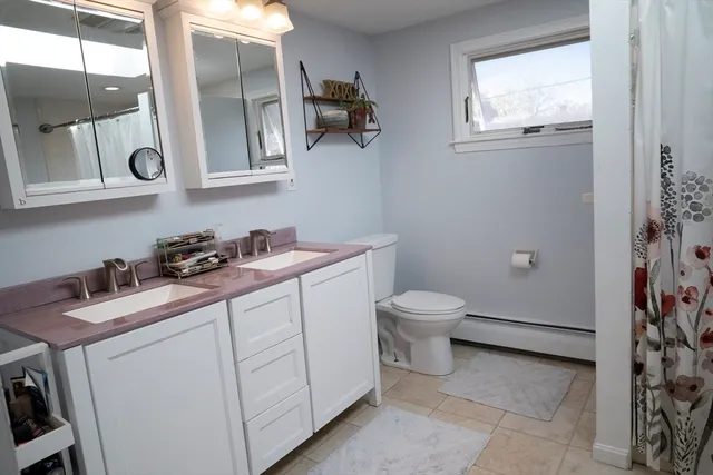 a bathroom with a toilet sink and mirror