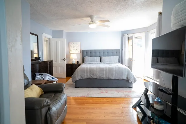 a bedroom with a bed and a flat screen tv