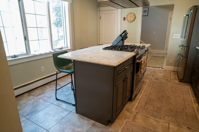a kitchen with stainless steel appliances granite countertop a sink and a refrigerator