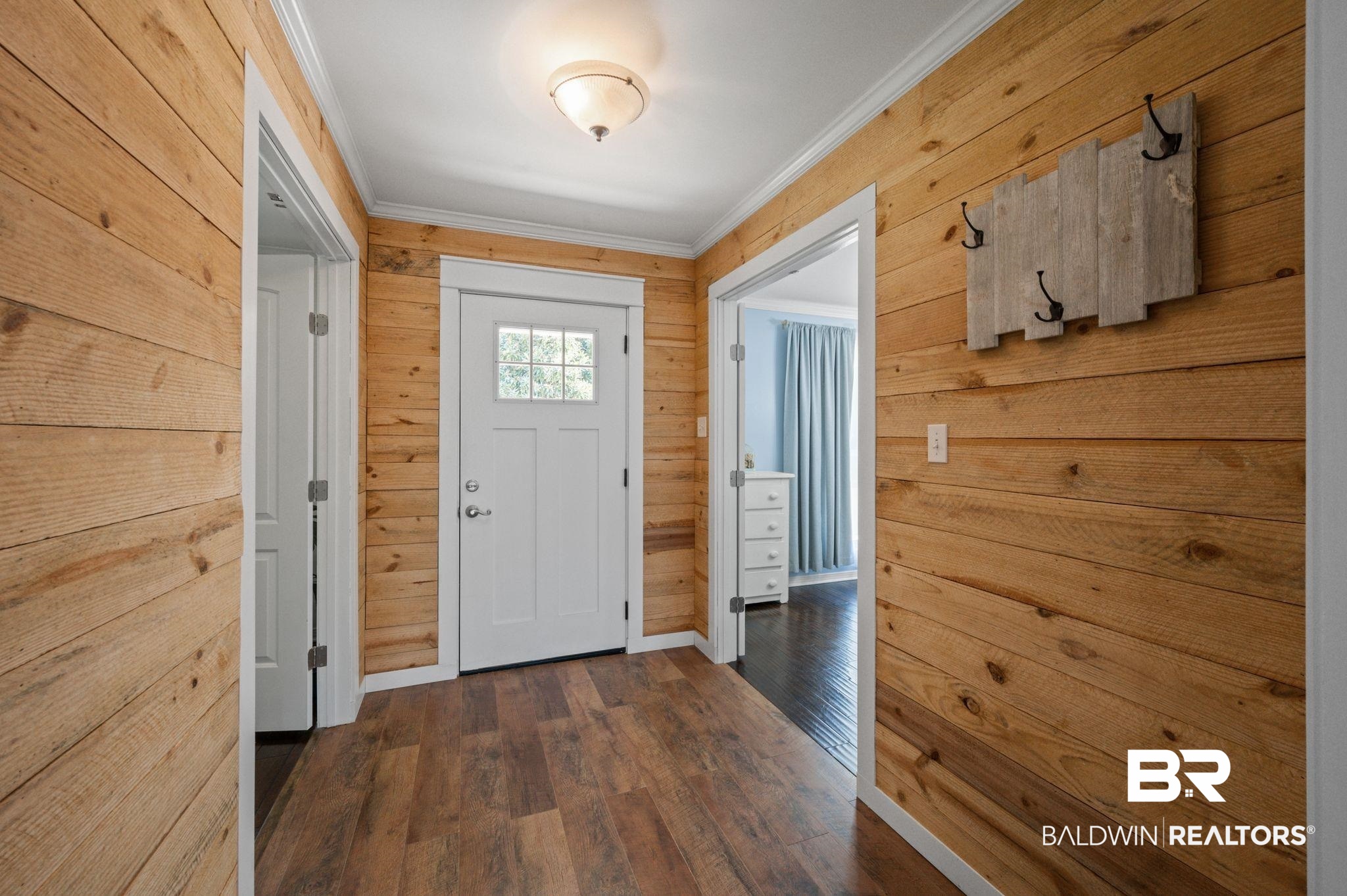 20037 County Road 33 Fairhope, AL 36532 - Photo 5 of 79 Doorway to outside featuring ornamental molding, wooden walls, and dark wood-type flooring