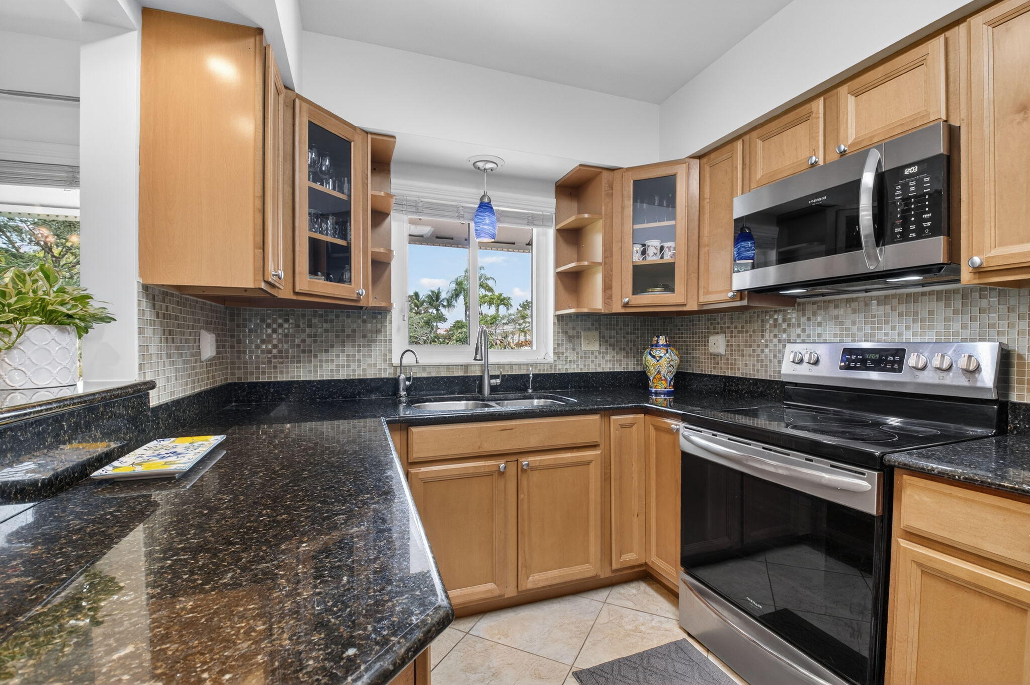 400 East Conference Drive Boca Raton, FL 33486 - Photo 14 of 41 a kitchen with stainless steel appliances granite countertop a stove sink and microwave