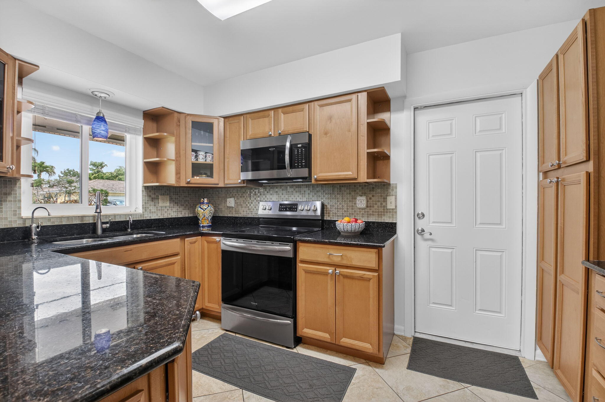 400 East Conference Drive Boca Raton, FL 33486 - Photo 15 of 41 a kitchen with stainless steel appliances granite countertop a stove a sink and a microwave