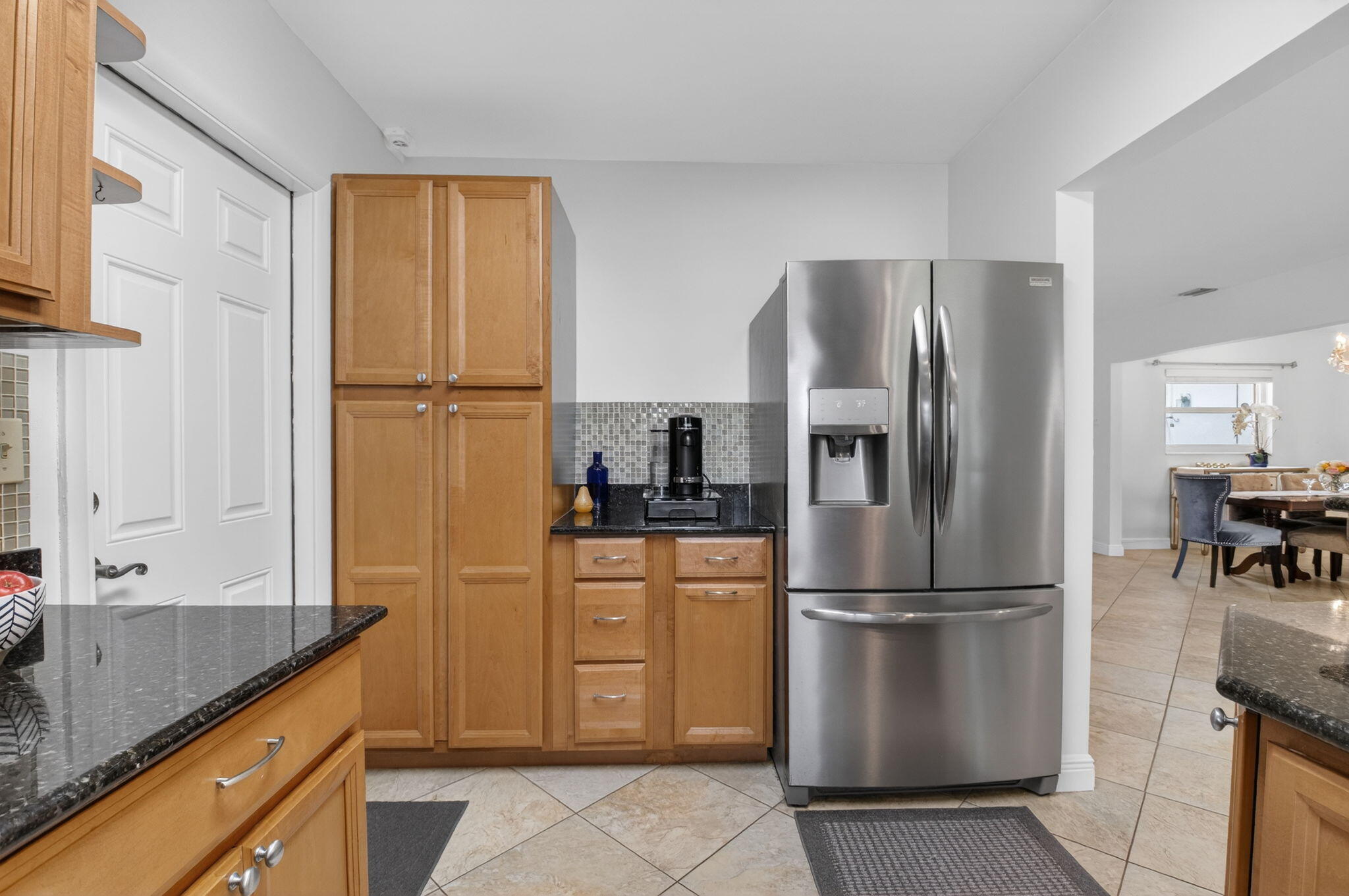 400 East Conference Drive Boca Raton, FL 33486 - Photo 17 of 41 a kitchen with stainless steel appliances granite countertop a refrigerator and a sink