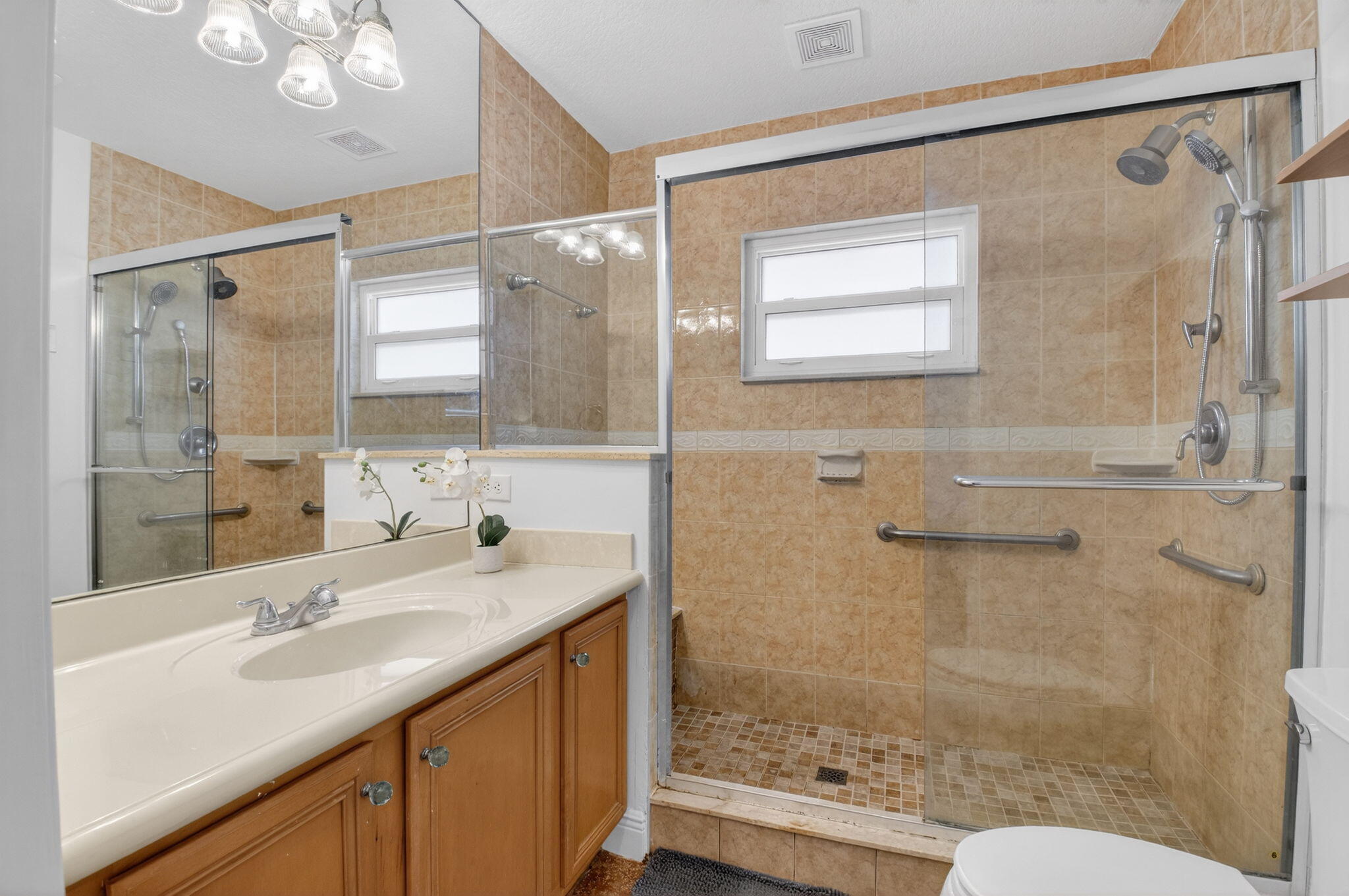 400 East Conference Drive Boca Raton, FL 33486 - Photo 28 of 41 a bathroom with a sink a toilet and shower