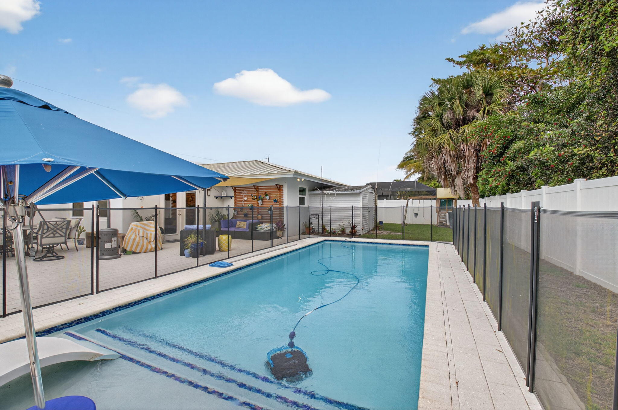 400 East Conference Drive Boca Raton, FL 33486 - Photo 37 of 41 a view of a swimming pool with a patio and a yard