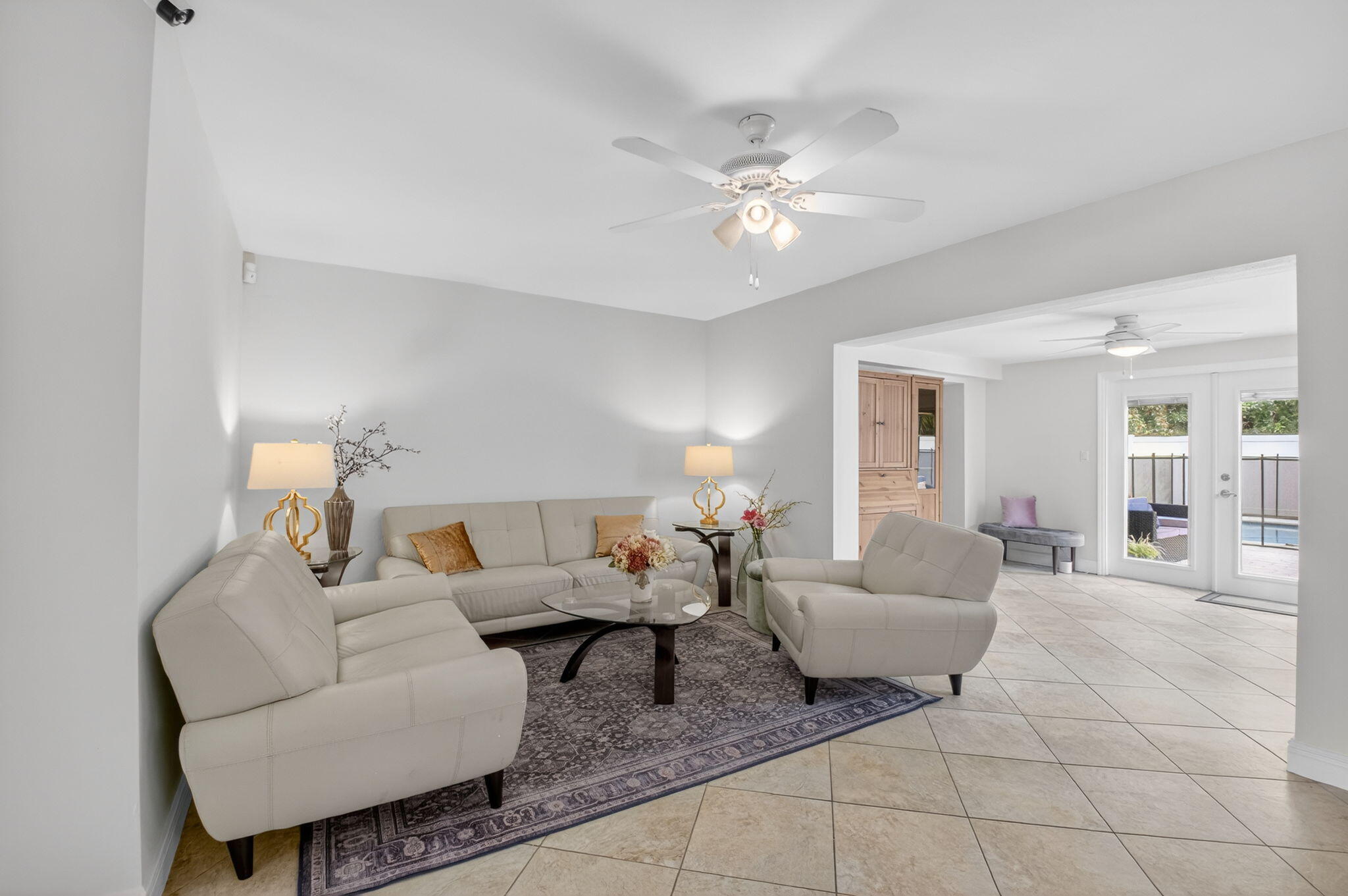 400 East Conference Drive Boca Raton, FL 33486 - Photo 8 of 41 a living room with furniture and a chandelier