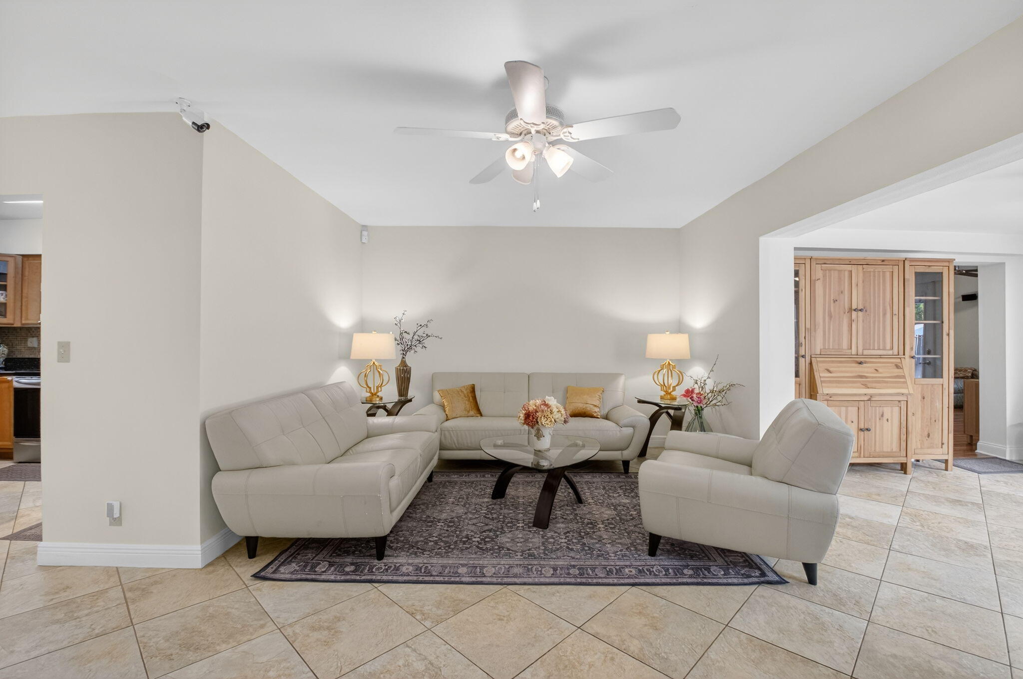 400 East Conference Drive Boca Raton, FL 33486 - Photo 9 of 41 a living room with furniture and a chandelier