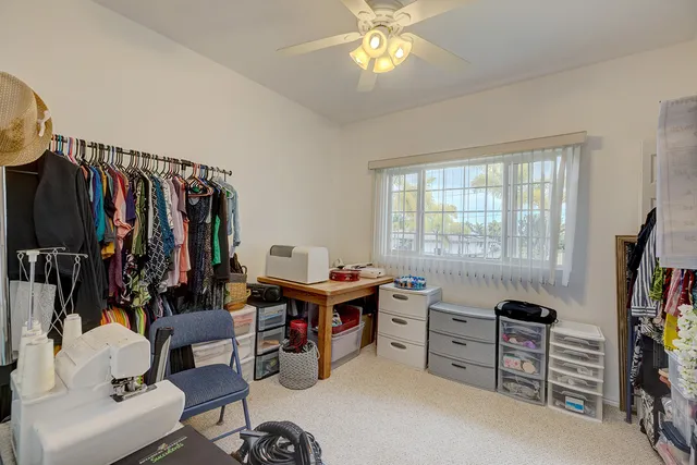 a view of a workspace with a window and lounge chair
