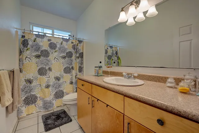 a bathroom with a sink a mirror and a shower