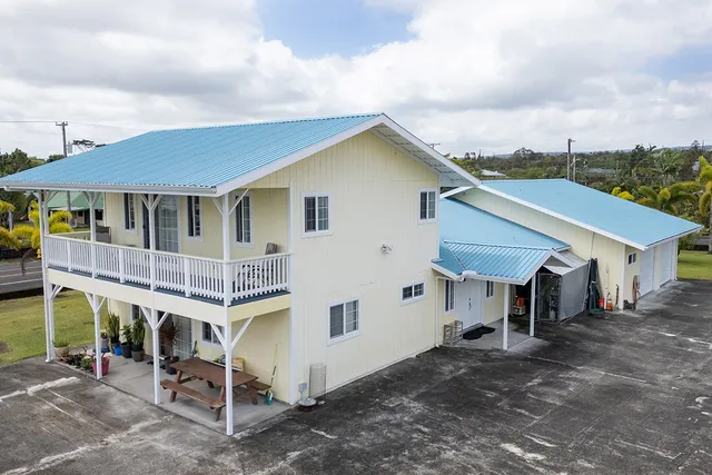 a view of a house with a yard and roof