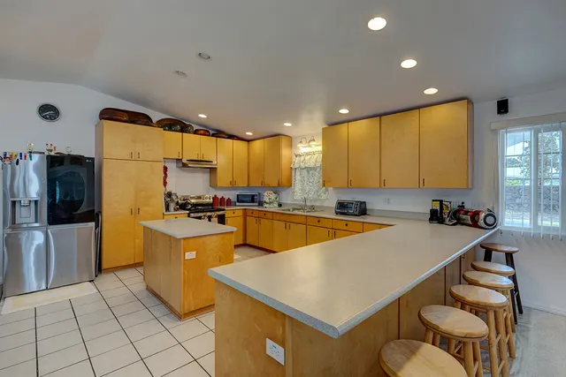 a large kitchen with a large counter top appliances and cabinets