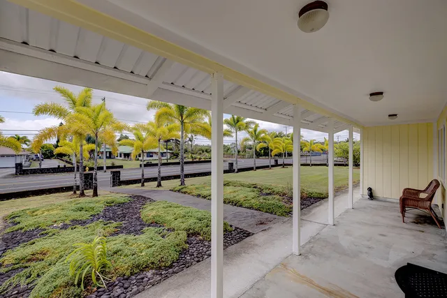 a view of a swimming pool with furniture