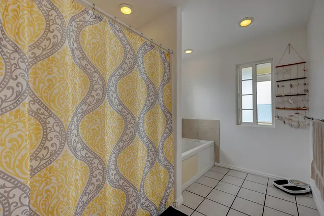 a bathroom with a bathtub and shower