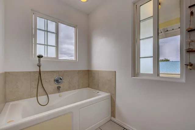 a bathroom with a bathtub and window
