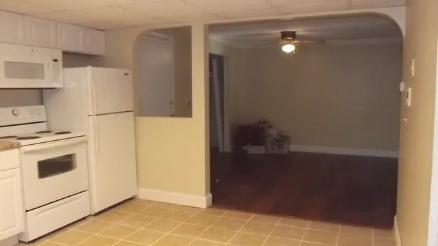 a kitchen with a refrigerator and a stove