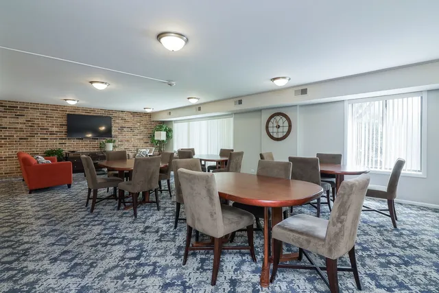 a view of a dining room with furniture and window