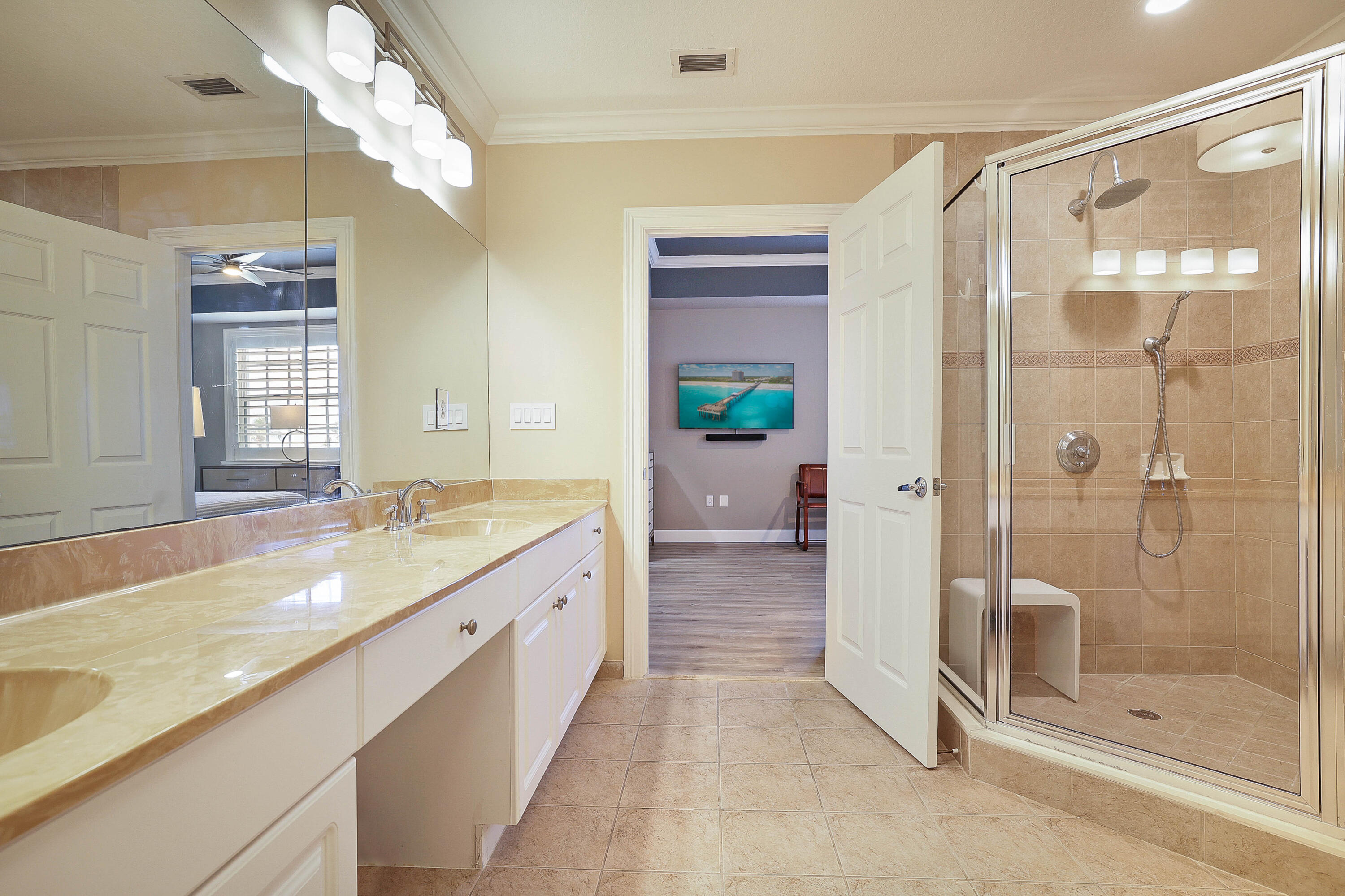810 Juno Ocean Walk, Unit 401B Juno Beach, FL 33408 - Photo 15 of 57 a bathroom with a granite countertop sink a mirror and a shower