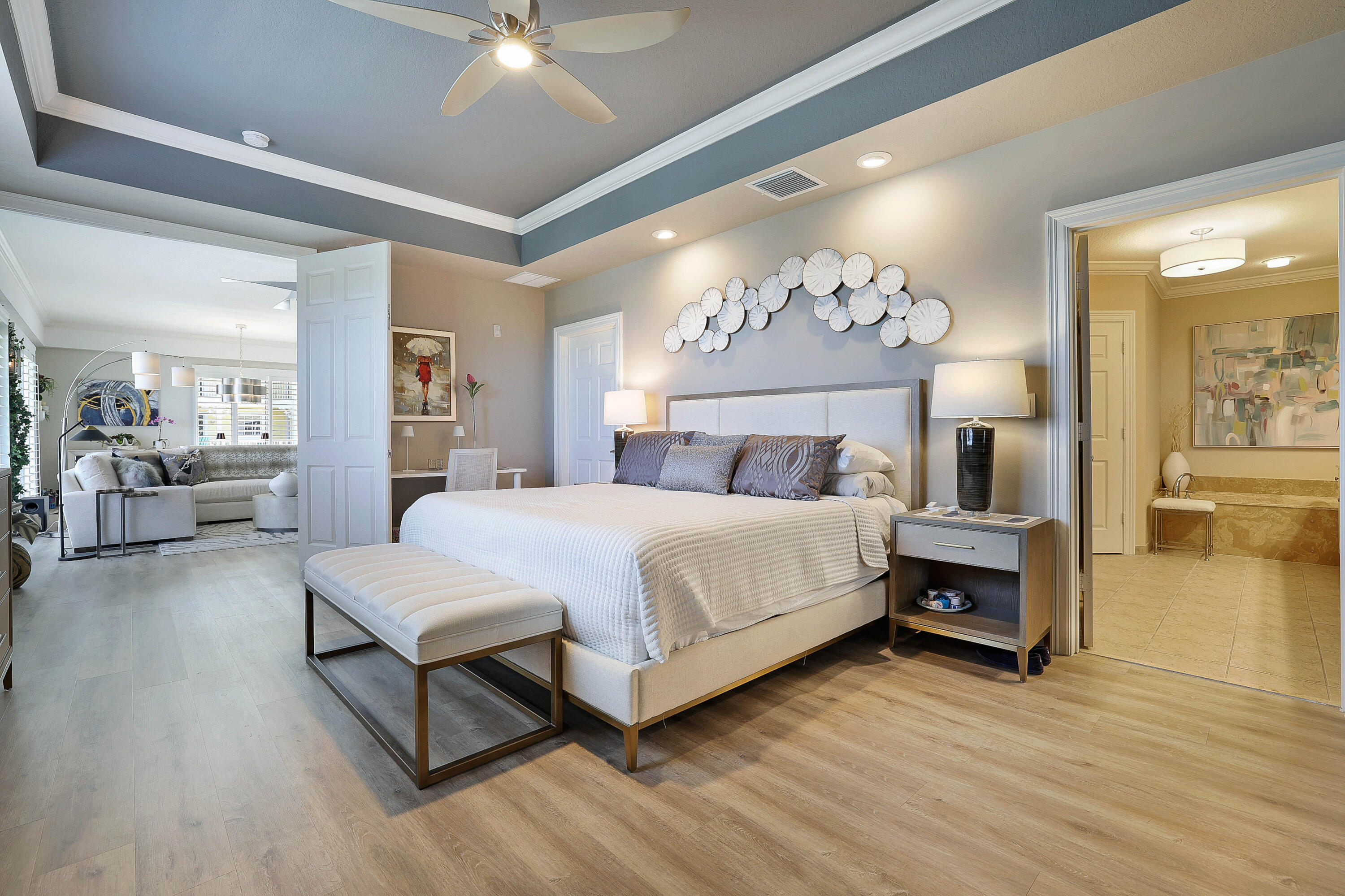 810 Juno Ocean Walk, Unit 401B Juno Beach, FL 33408 - Photo 34 of 57 a bedroom with a large bed and a chandelier