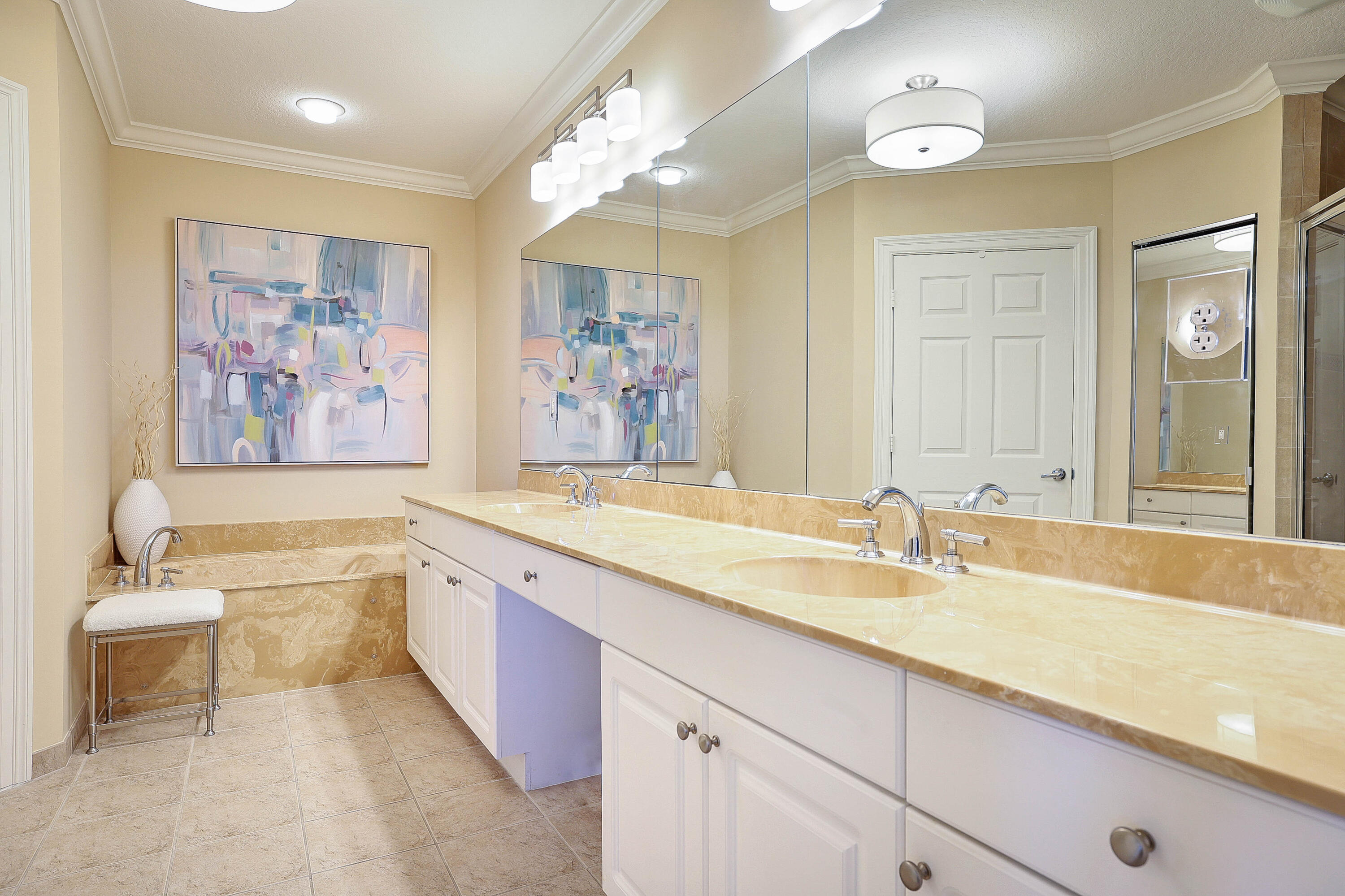 810 Juno Ocean Walk, Unit 401B Juno Beach, FL 33408 - Photo 36 of 57 a spacious bathroom with a sink a large mirror and a bathtub