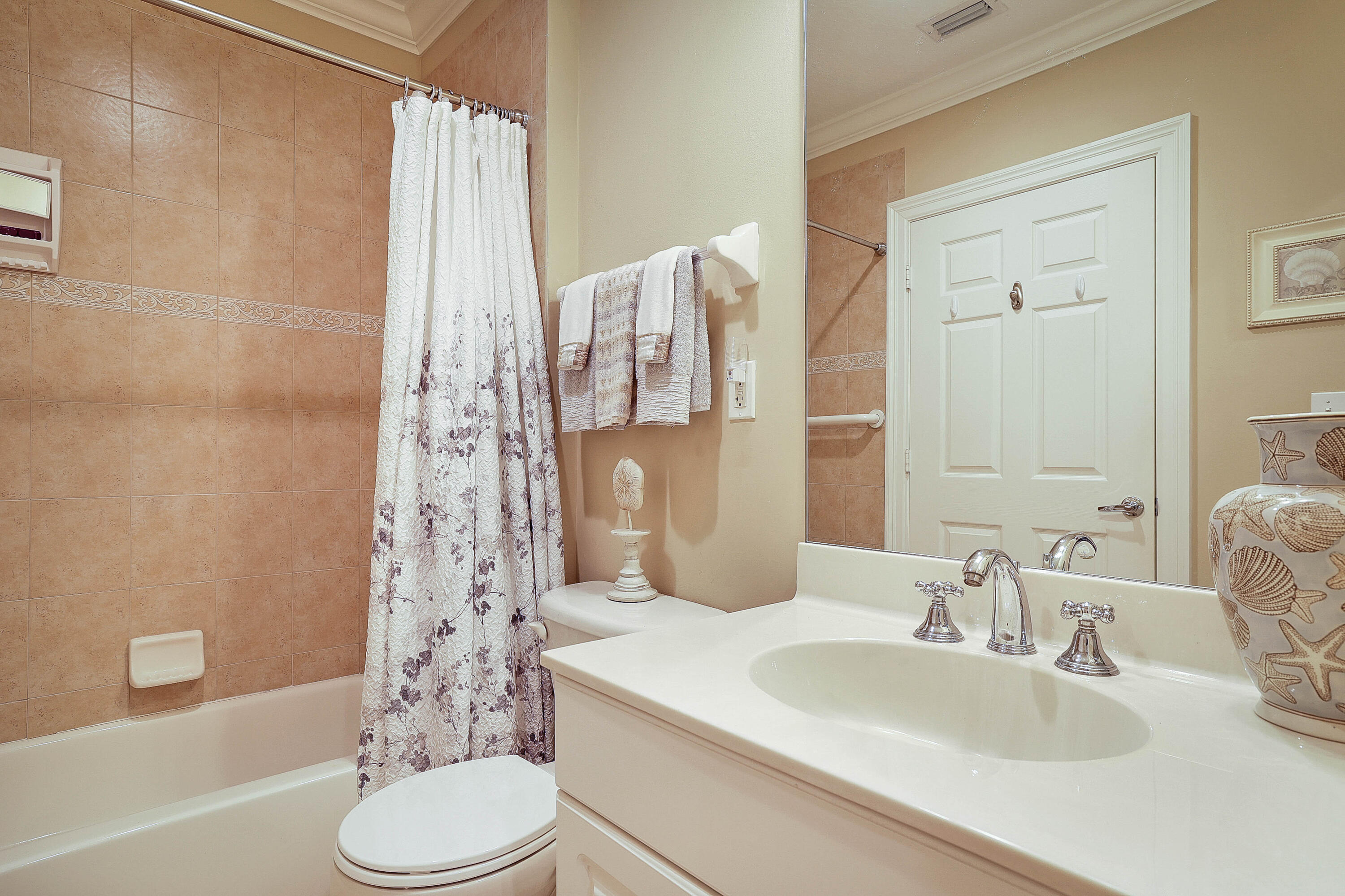 810 Juno Ocean Walk, Unit 401B Juno Beach, FL 33408 - Photo 40 of 57 a bathroom with a sink toilet and shower