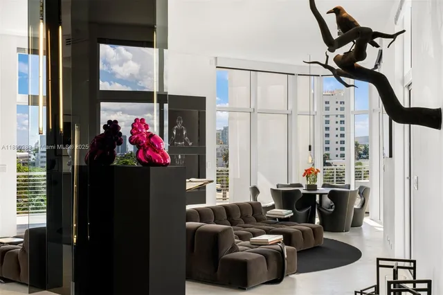 a living room with furniture a window and a flat screen tv