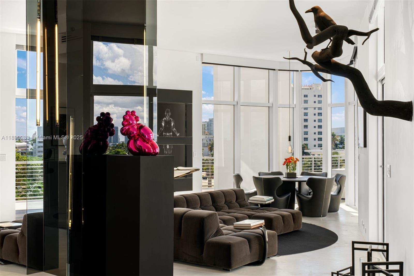 a living room with furniture a window and a flat screen tv