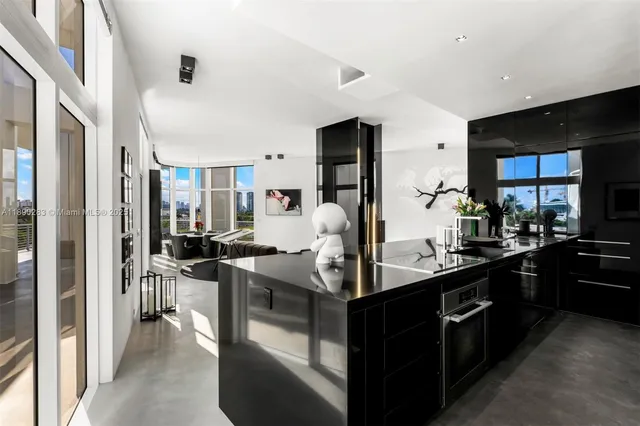 a living room with large windows and furniture