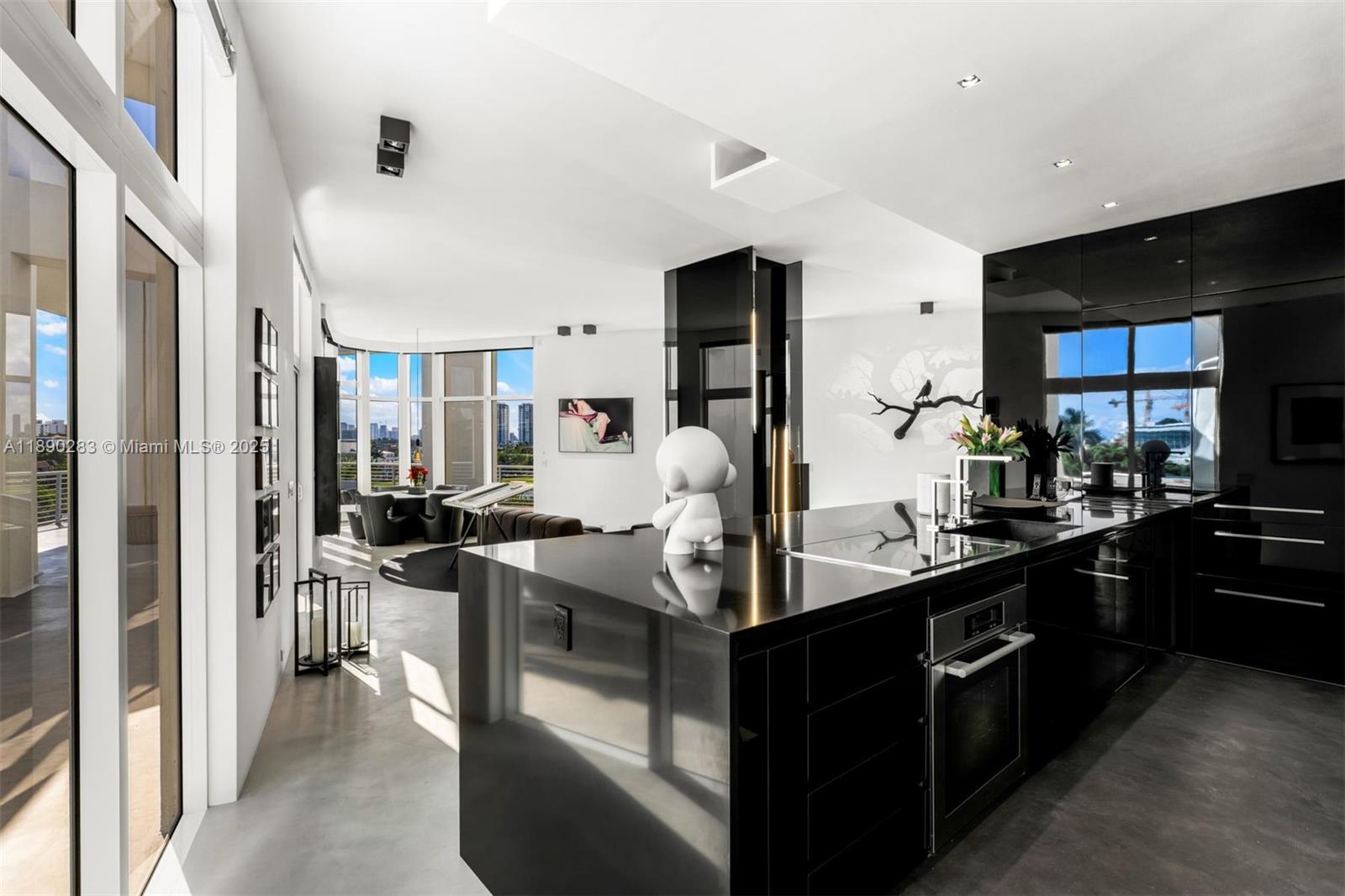 2001 Meridian Avenue, Unit PH01 Miami Beach, FL 33139 - Photo 11 of 63 a kitchen with stainless steel appliances granite countertop a sink stove and refrigerator