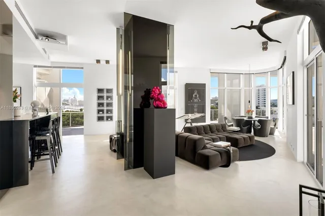 a living room with furniture a flat screen tv and a window