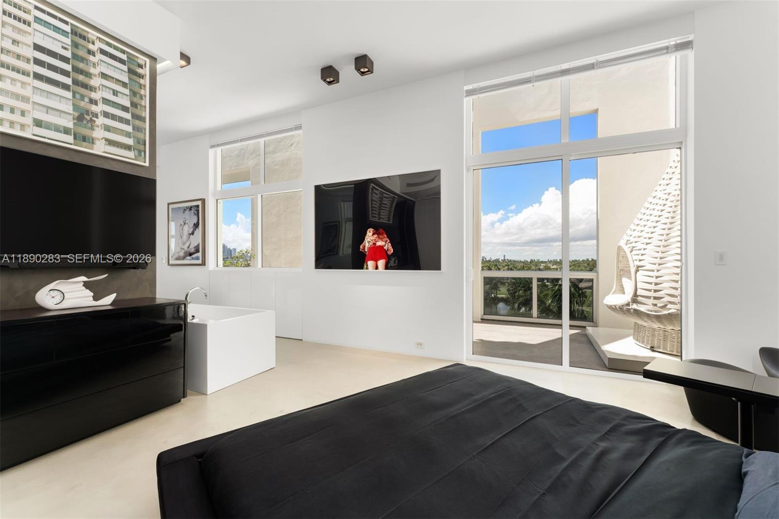 2001 Meridian Avenue, Unit PH01 Miami Beach, FL 33139 - Photo 22 of 63 a living room with furniture and a flat screen tv