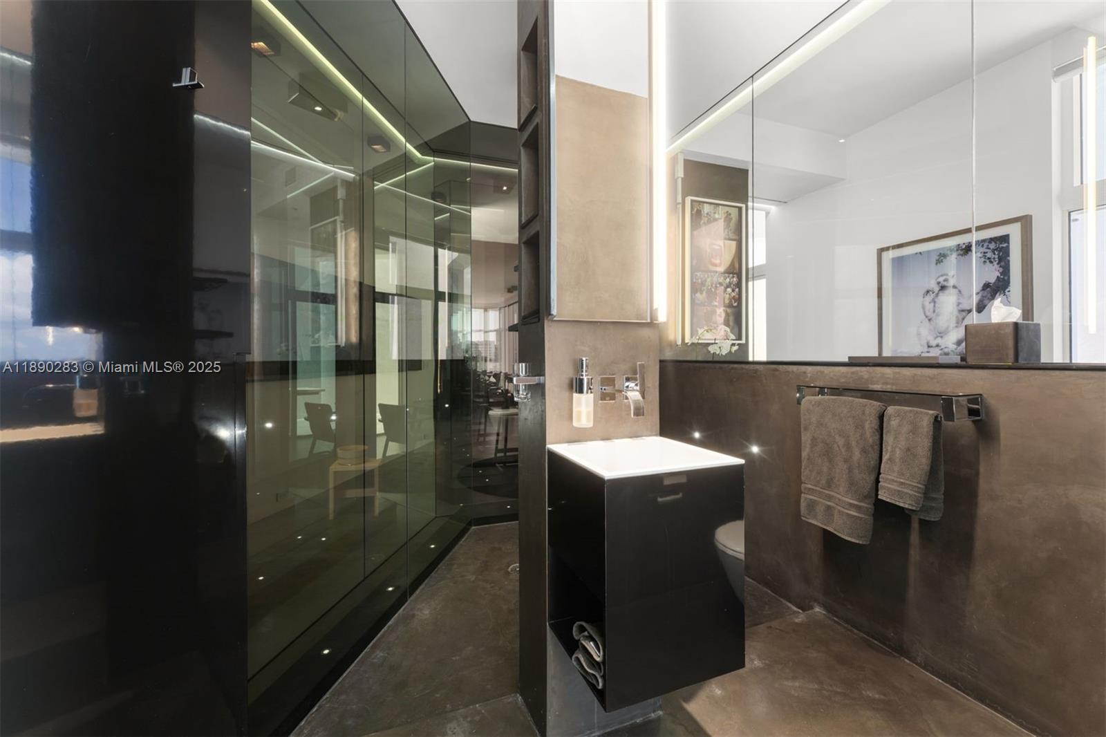 2001 Meridian Avenue, Unit PH01 Miami Beach, FL 33139 - Photo 23 of 63 a bathroom with a sink a mirror and shower