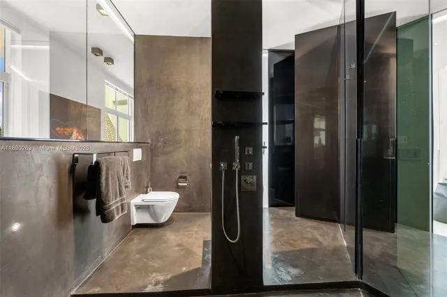 a view of a living room and floor to ceiling window and kitchen view