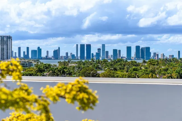 a view of a balcony with yard & street
