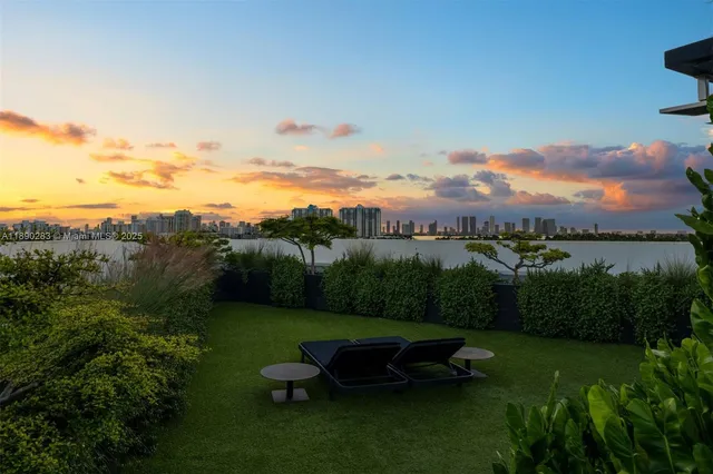 an aerial view of a house with garden space and outdoor seating