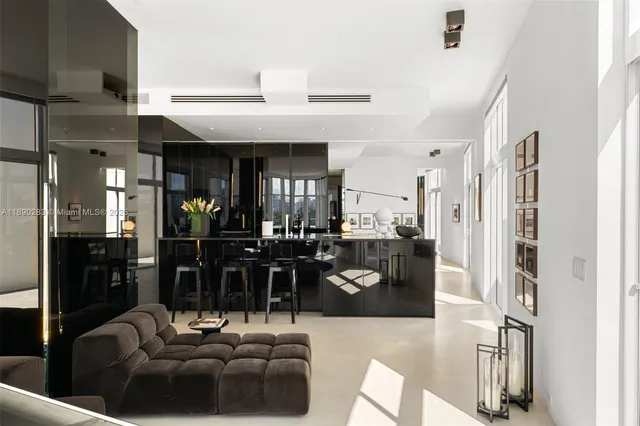 a living room with stainless steel appliances kitchen island granite countertop furniture and a view of living room