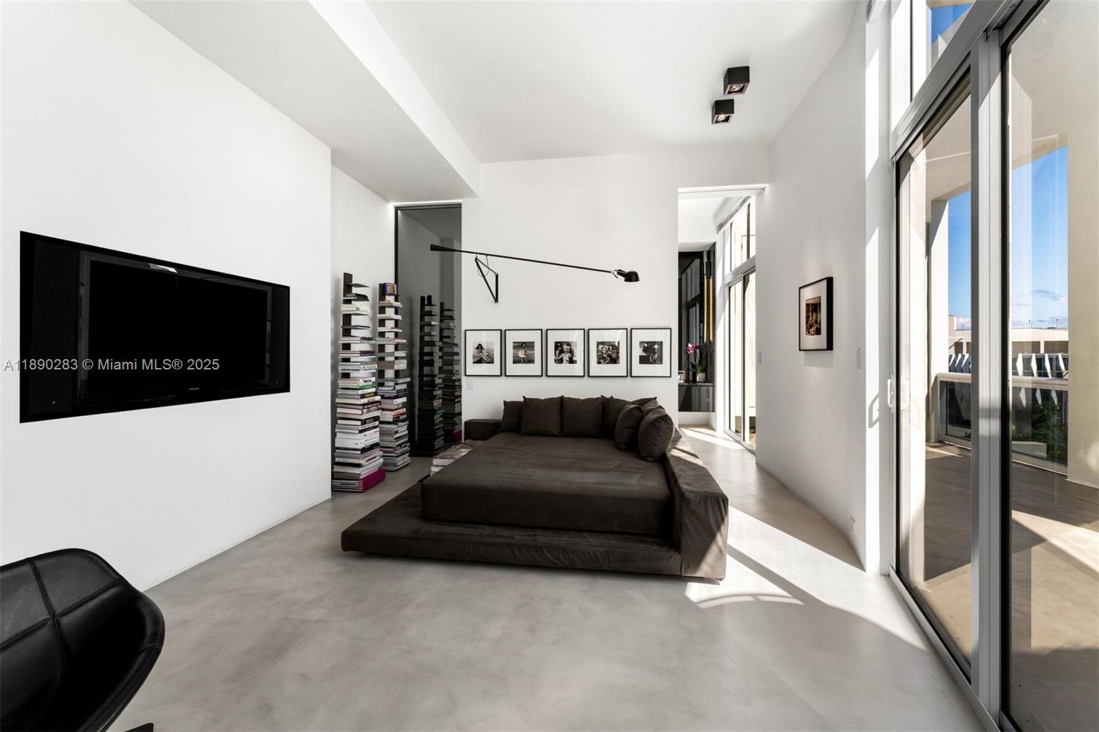 2001 Meridian Avenue, Unit PH01 Miami Beach, FL 33139 - Photo 7 of 63 a living room with a couch and a flat screen tv