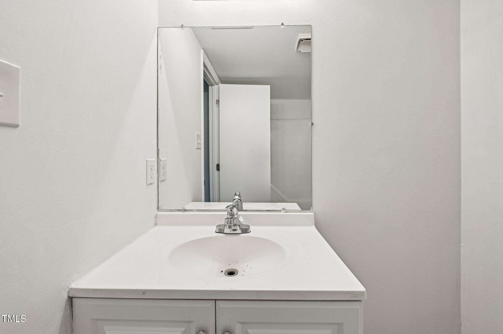 642 Pine Ridge Place Raleigh, NC 27609 - Photo 9 of 15 a bathroom with a sink and a mirror