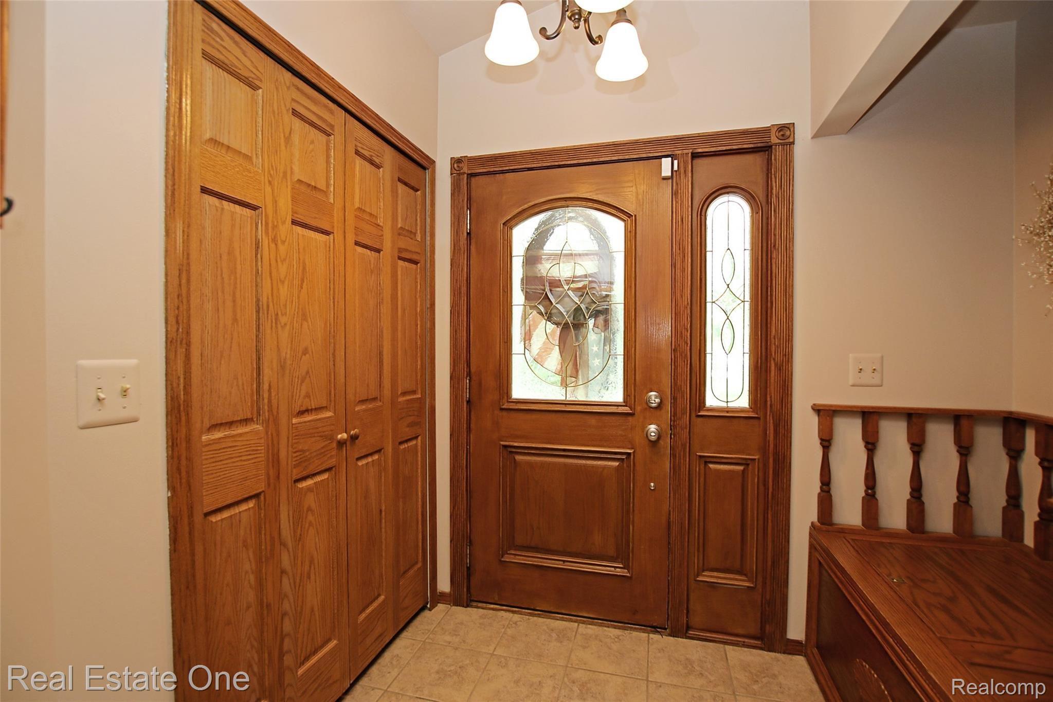 5621 Rochester Road Dryden, MI 48428 - Photo 8 of 52 Large Foyer with built in bench and ceramic tile floor