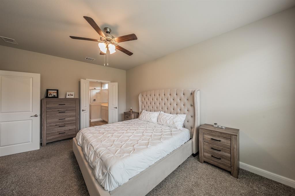 1212 Bosque Lane Weatherford, TX 76087 - Photo 25 of 38 a bedroom with a bed and a chandelier
