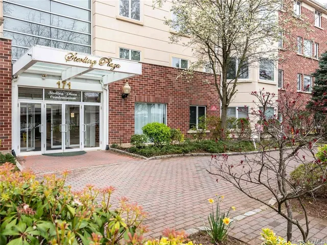 a front view of a building with a garden